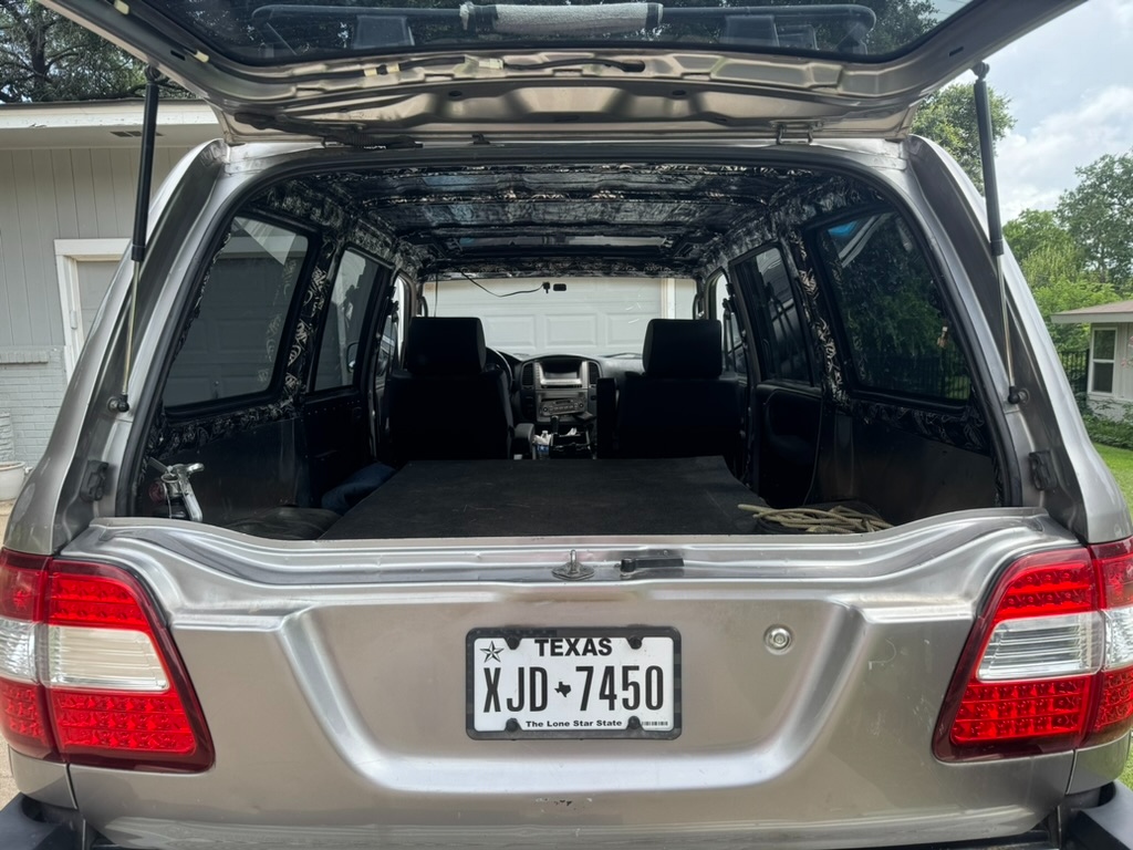 Rear hatch open, ARB swing-out, Texas license plate XJD 7450