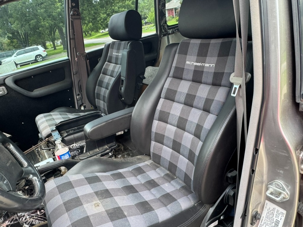 Scheelmann racing seats with grey checkered fabric and black leather bolsters