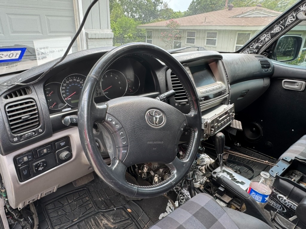 Dash, steering wheel, and front cabin of the Land Cruiser