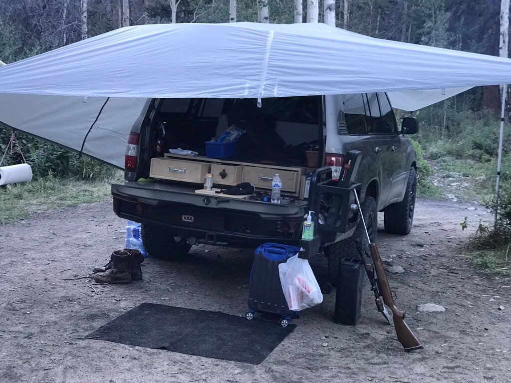 Land Cruiser Panhandle Expedition build — fully loaded overlander, roof rack, light bar, 33-inch KO2s, camp scene