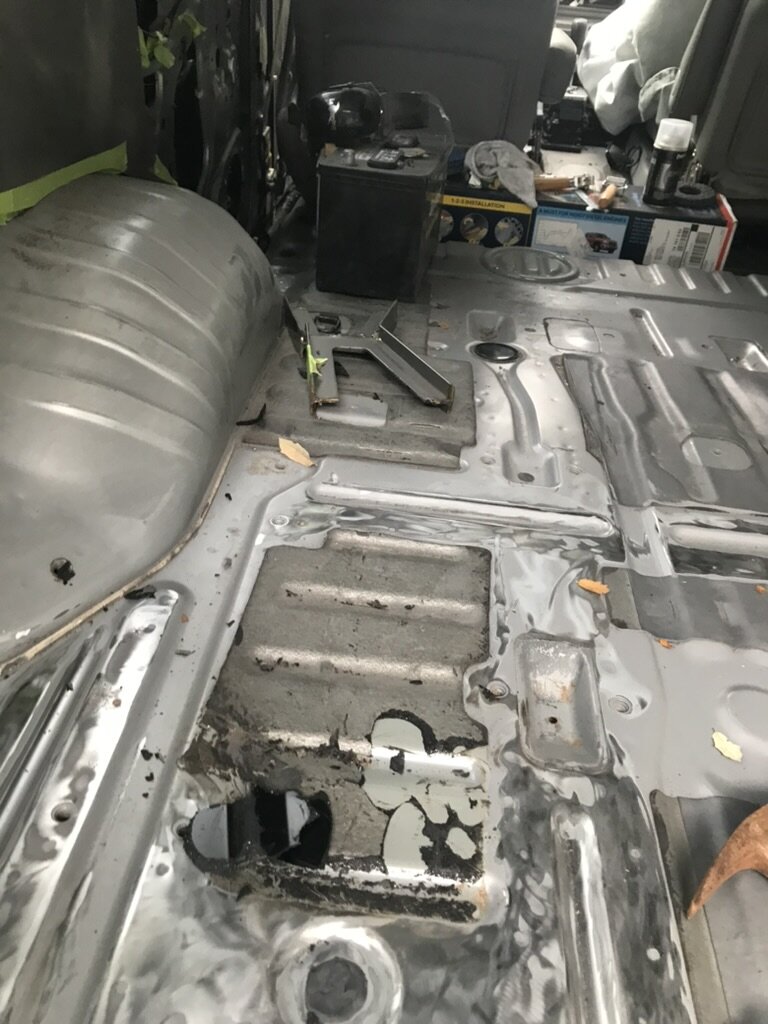 Land Cruiser floor pan hand-ground for 40 hours and acid-etched — mechanical proof, the work most builders never do