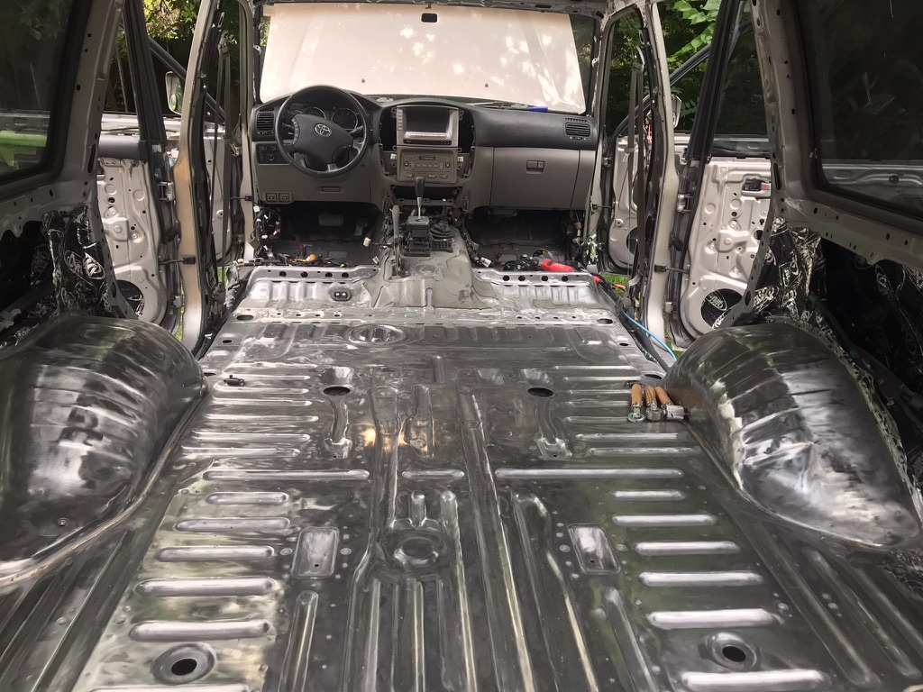 Bare steel floor of Land Cruiser cabin during 40-hour resurrection — money shot