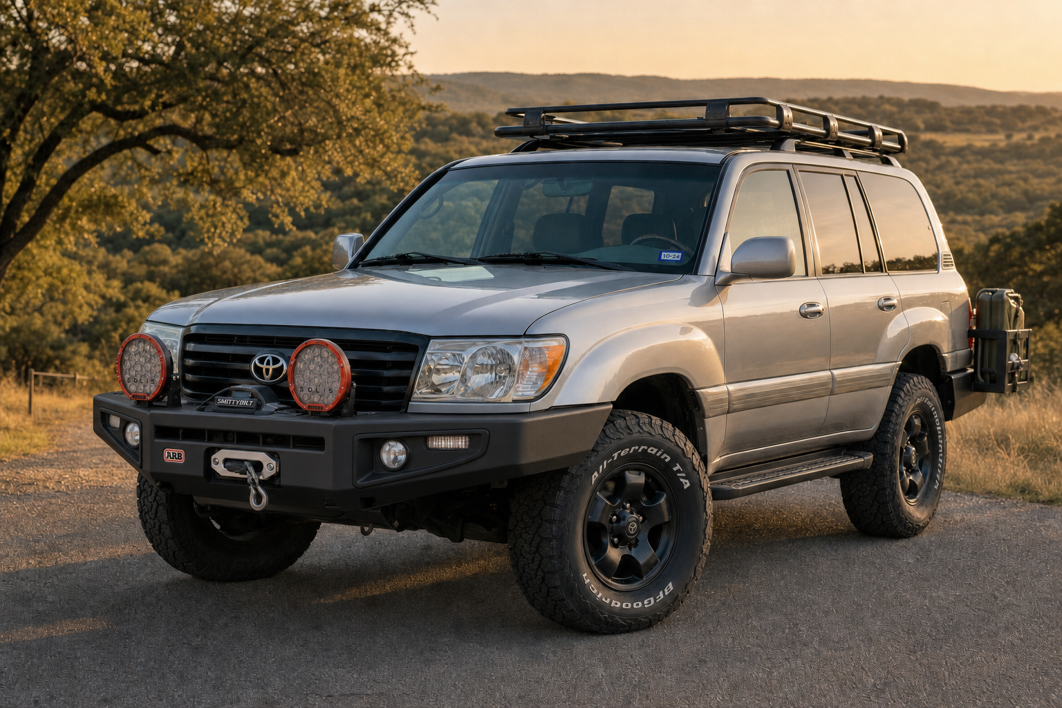 Titanium Edition concept render — Don's actual Land Cruiser resprayed in matte titanium silver with color-matched ARB bumper, black wheels, golden hour Texas hill country
